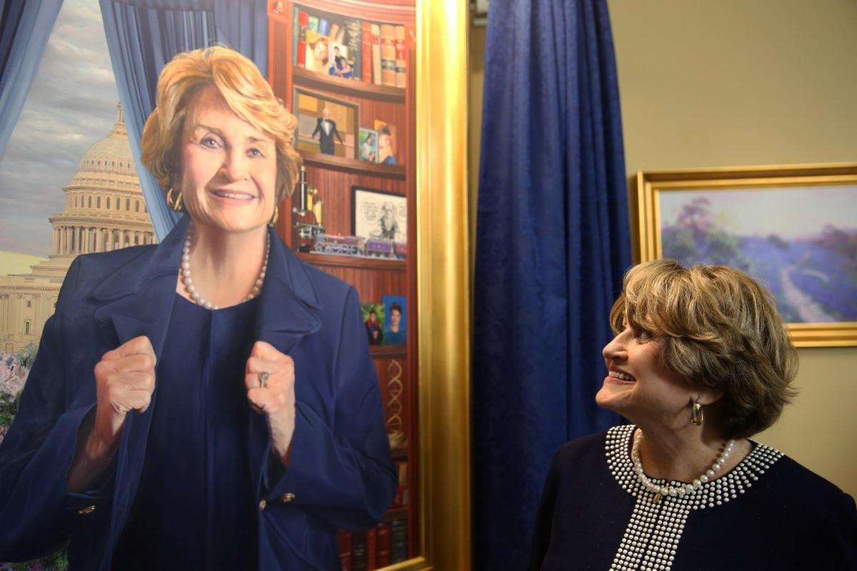 Louise Slaughter looking at a portrait of herself