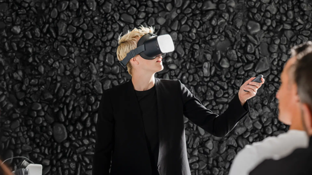 A woman in a black jacket and shirt is using a VR headset.