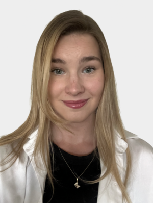 A person, Luidmila Paymukhina, with long straight caramel blonde hair smiles for the camera